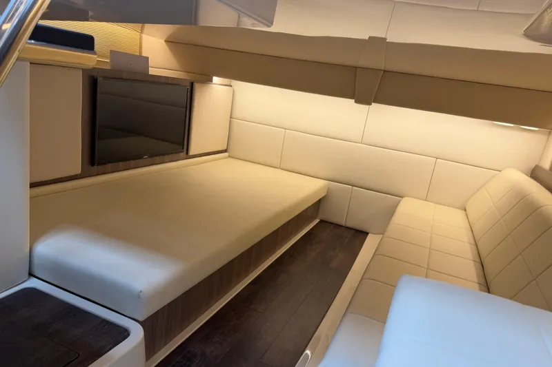 Slide: The Image of Luxurious interior of 2021 Regal 36 XO yacht with beige seating and mounted TV. - 53