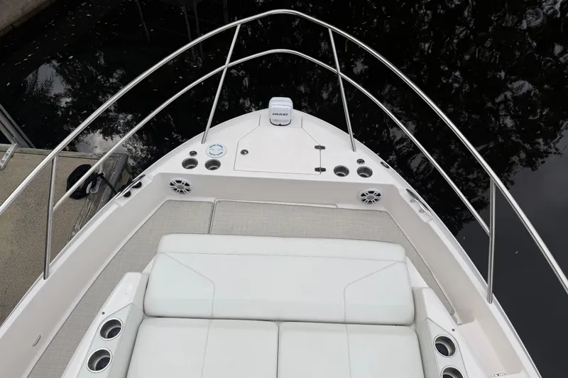 Slide: The Image of 2021 Regal 36 XO boat deck with seating and railing, docked by water. - 59