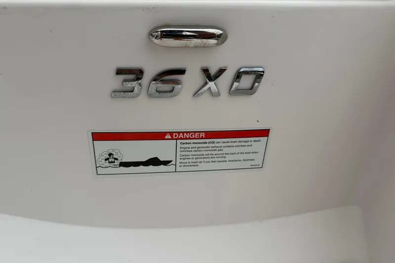 Slide: The Image of 2021 Regal 36 XO boat model emblem with safety warning label. - 66