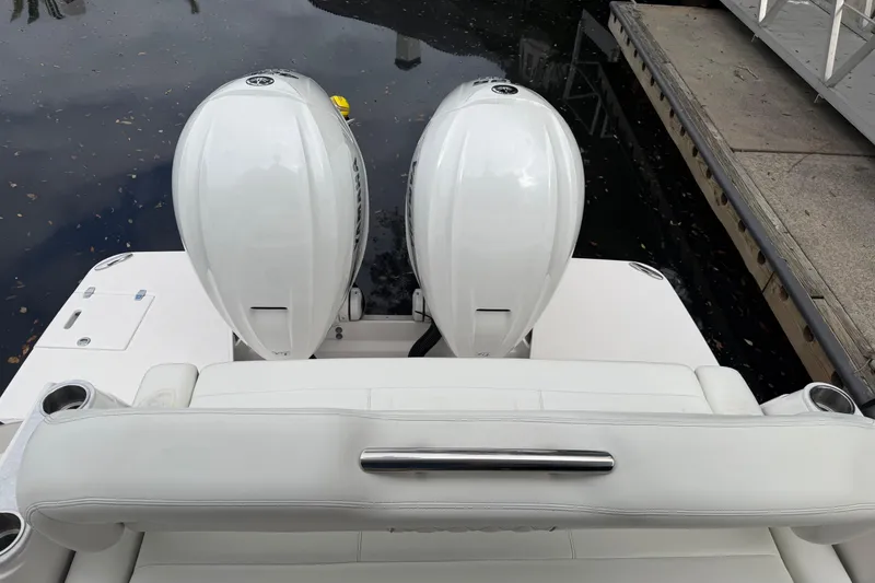 Slide: The Image of 2021 Regal 36 XO boat with dual outboard engines at dockside. - 7