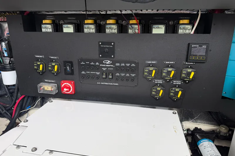Slide: The Image of Control panel of a 2021 Regal 36 XO boat with various switches and gauges. - 73