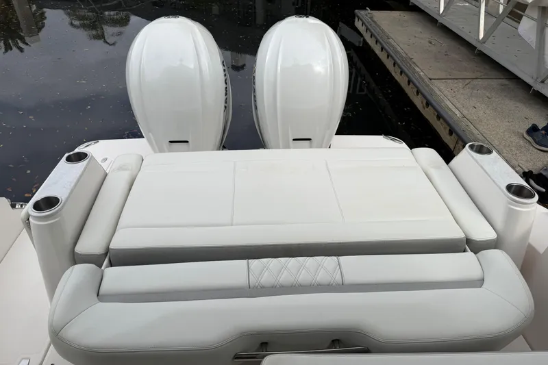 Slide: The Image of 2021 Regal 36 XO boat with dual outboard engines and cushioned seating. - 8