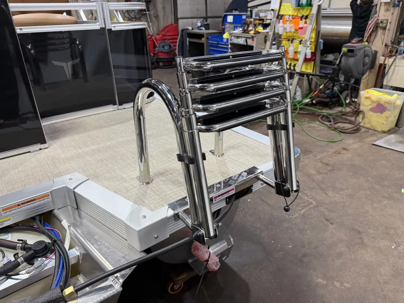 Slide: The Image of Tahoe Sport 23E80 pontoon boat with stainless steel ladder, workshop setting. - 40