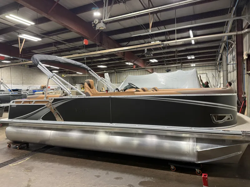 Slide: The Image of 2026 Tahoe LTZ 2385 Elite Cruise Tritoon in a workshop. - 44
