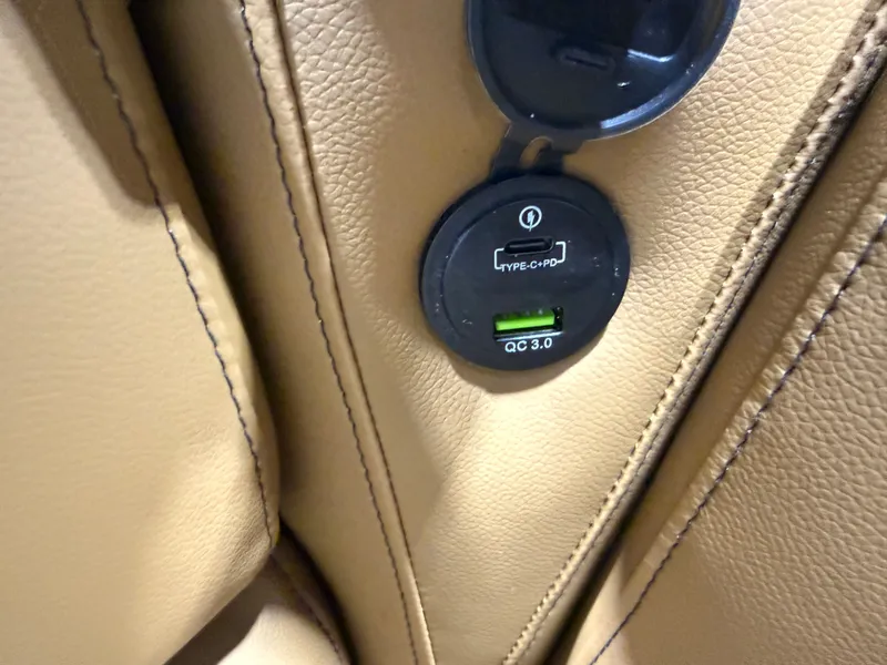 Slide: The Image of USB charging port in beige Tahoe Sport 1980, model 2026. - 27