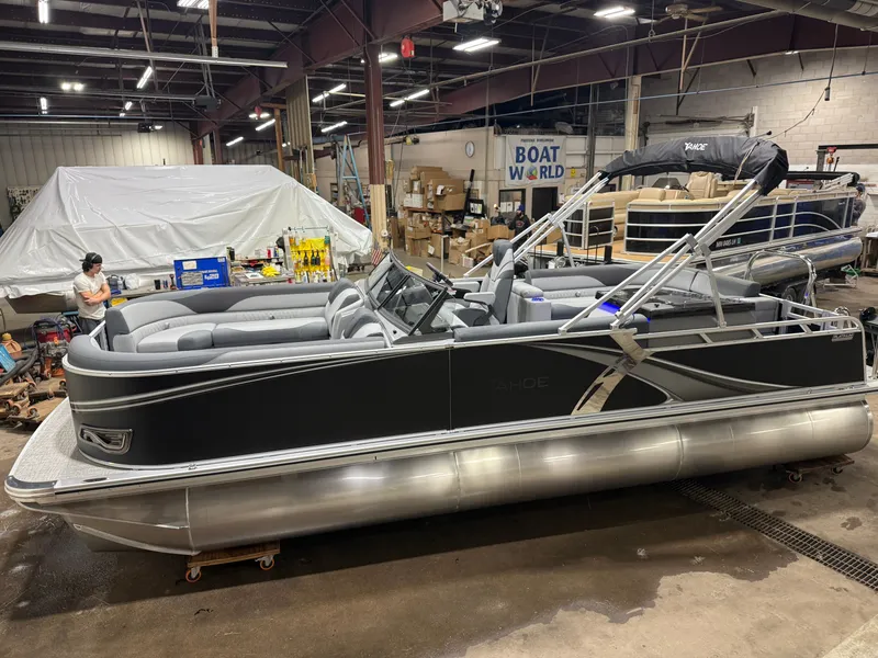 The Image of 2026 Tahoe LTZ 2385 Tritoon in showroom, featuring Honda 4-Stroke EFI. - 1