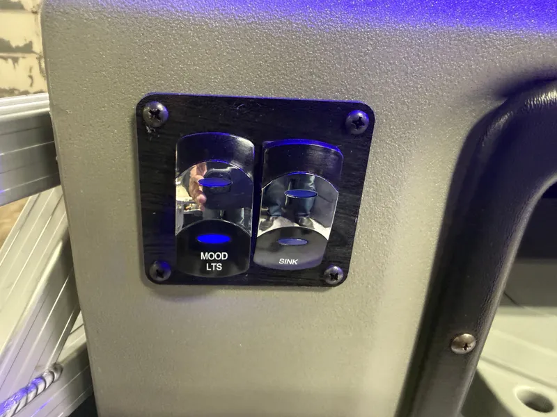 Slide: The Image of Mood lighting and sink switches on a 2026 Tahoe Tritoon. - 26