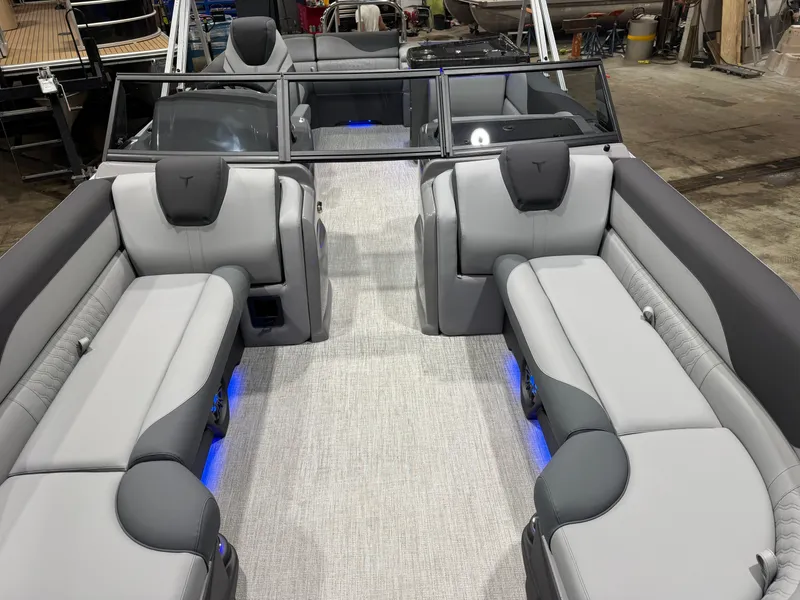 Slide: The Image of Interior of 2026 Tahoe LTZ 2385 Elite Tritoon with gray seating. - 8