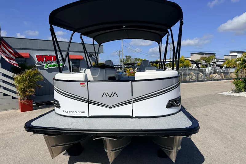 Slide: The Image of 2026 Avalon 2385 LSZ Versatile Rear Bench Tri Toon boat at marina, sunny day. - 3