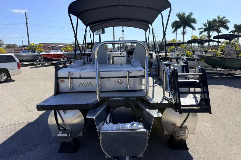 Slide: The Image of 2026 Avalon 2385 LSZ Versatile Rear Bench Tri Toon boat in a sunny marina setting. - 7