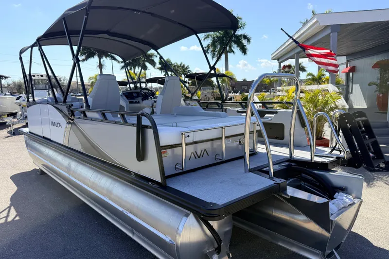 Slide: The Image of 2026 Avalon 2385 LSZ Versatile Rear Bench Tri Toon boat with canopy and American flag. - 8