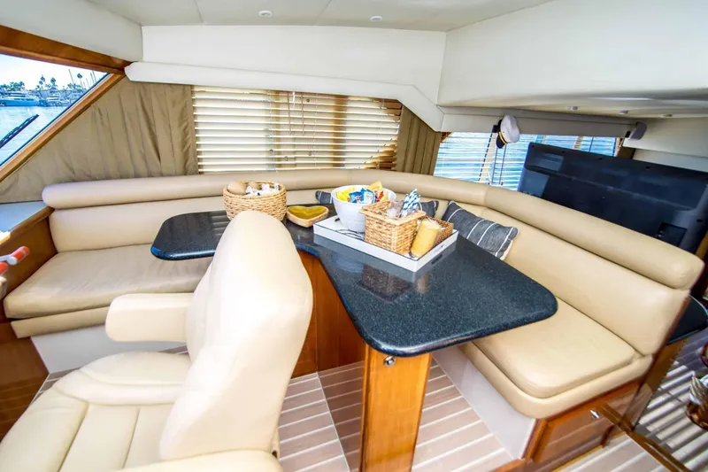 Slide: The Image of Luxurious 2005 Navigator 4400 Pilothouse yacht interior with leather seating and dining area. - 12