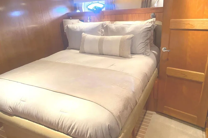 Slide: The Image of Cozy bedroom interior in 2005 Navigator 4400 Pilothouse yacht with plush bedding. - 19