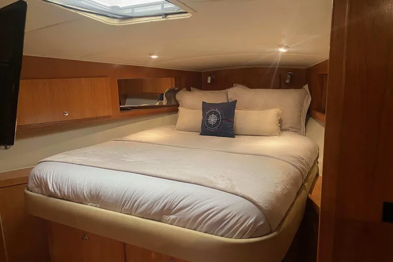 Slide: The Image of Luxurious bedroom in 2005 Navigator 4400 Pilothouse yacht with cozy bedding. - 2