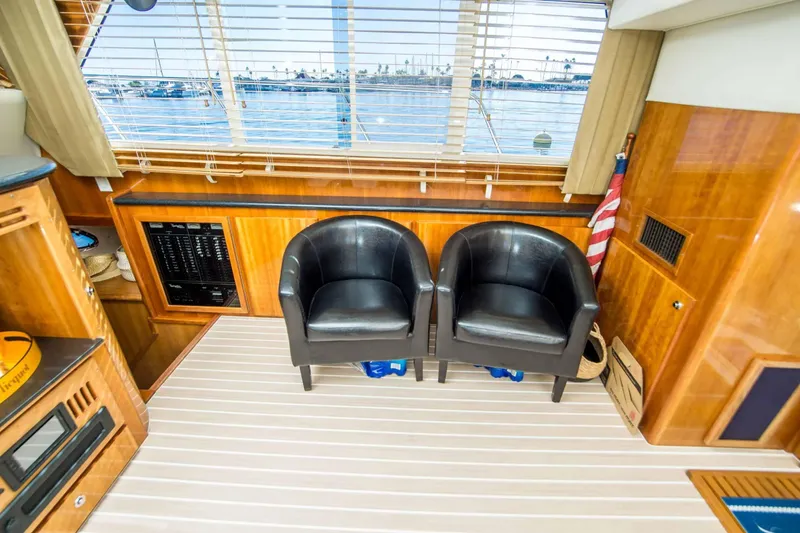 Slide: The Image of Interior of 2005 Navigator 4400 Pilothouse with leather chairs and wood paneling. - 6