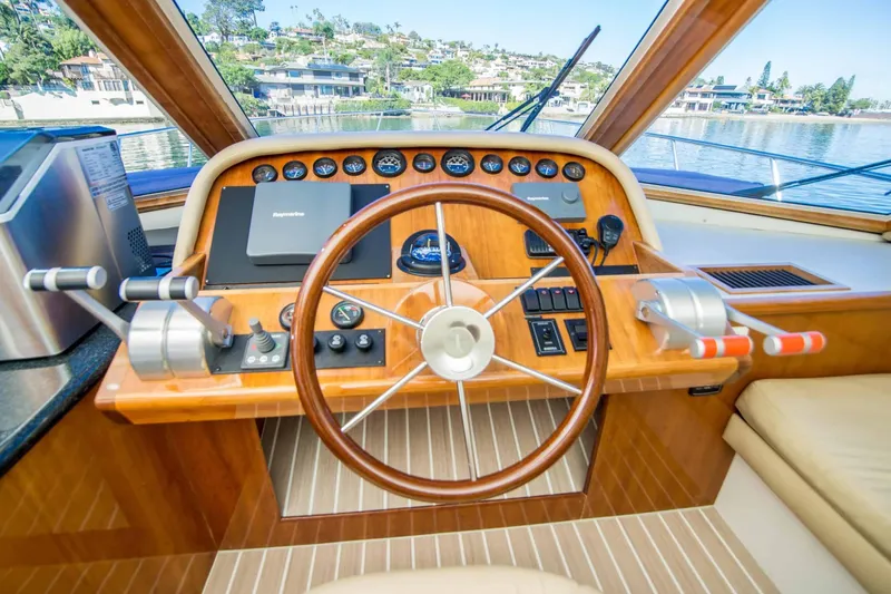 Slide: The Image of Pilothouse of 2005 Navigator 4400, featuring wooden steering wheel and control panel. - 7