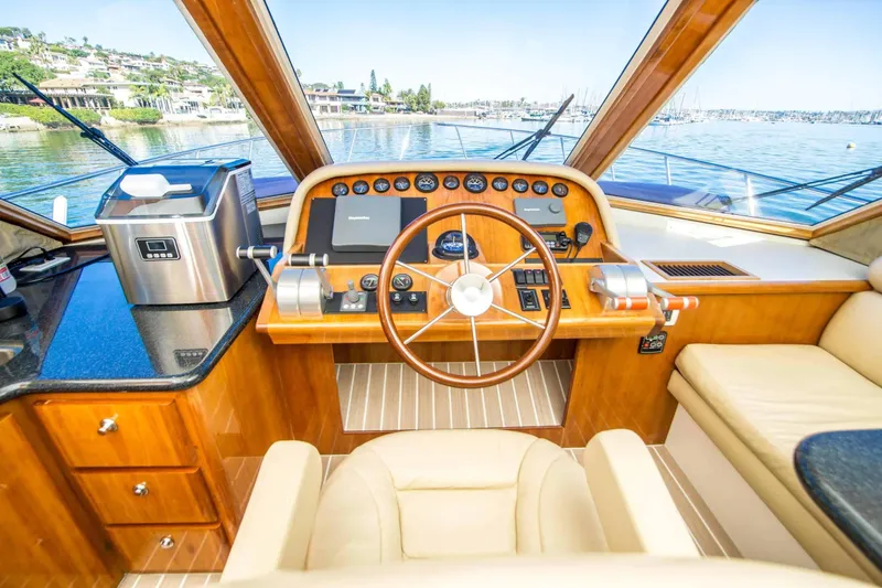 Slide: The Image of Pilothouse interior of 2005 Navigator 4400, featuring wooden dashboard and steering wheel. - 8