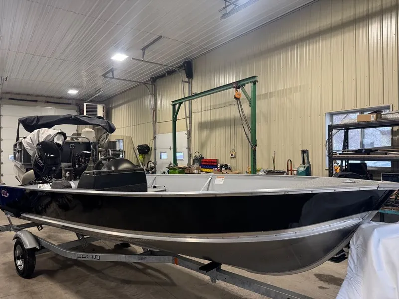 Slide: The Image of 2026 Lund SSV-18 boat in a workshop on a trailer. - 6