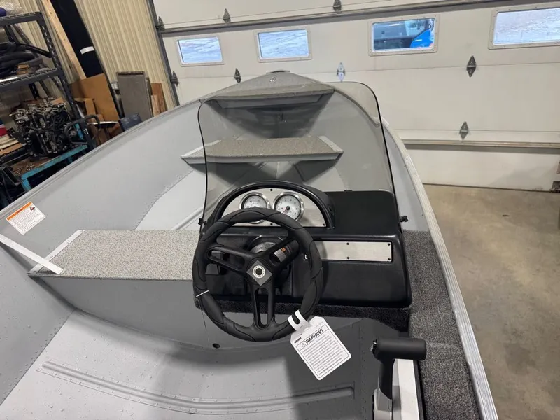 Slide: The Image of Interior view of a 2026 Lund SSV-18 boat in a garage. - 7