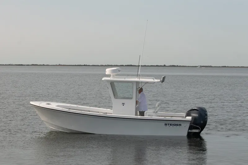 Slide: The Image of 2026 Steiger Craft 23 Chatham boat on calm water, side view. - 2