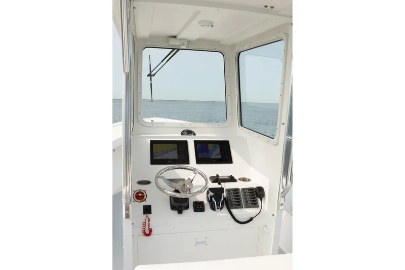 Slide: The Image of Interior view of 2026 Steiger Craft 23 Chatham boat cockpit with navigation controls. - 3