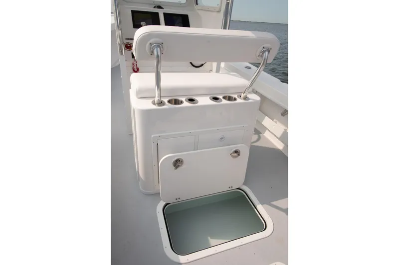 Slide: The Image of 2026 Steiger Craft 23 Chatham boat interior with storage compartment and rod holders. - 4