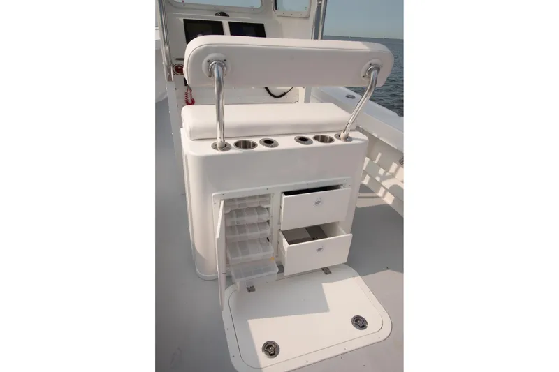 Slide: The Image of 2026 Steiger Craft 23 Chatham boat interior with storage compartments and rod holders. - 6