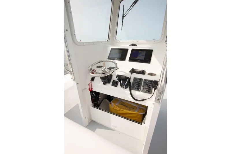 Slide: The Image of Steiger Craft 23 Chatham 2026 boat console with steering wheel and navigation screens. - 8