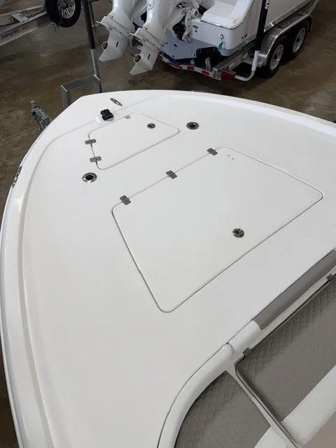 Slide: The Image of Deck of a 2024 Caymas 28 HB boat with storage compartments. - 10