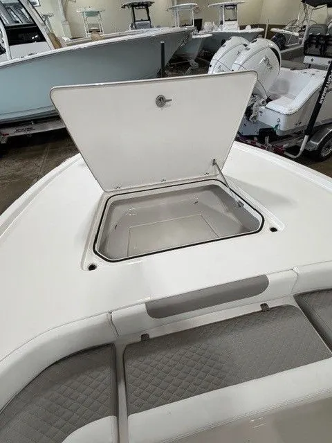 Slide: The Image of Open storage compartment on a 2024 Caymas 28 HB boat. - 9
