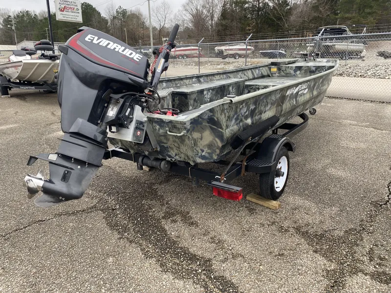 Slide: The Image of 2011 War Eagle 648LDV boat with Evinrude motor on trailer. - 3
