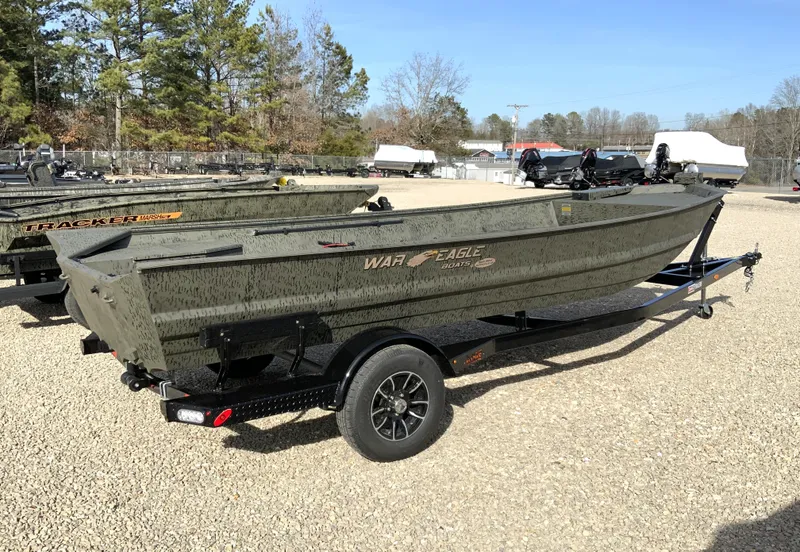 Slide: The Image of War Eagle 860LDV 2026 boat on trailer outdoors. - 2
