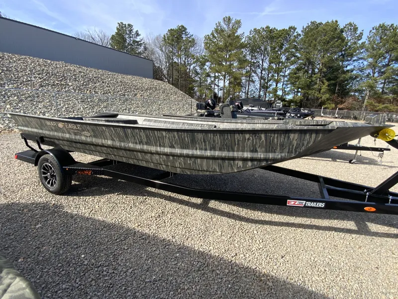 Slide: The Image of War Eagle 860LDV 2026 boat on trailer outdoors. - 10