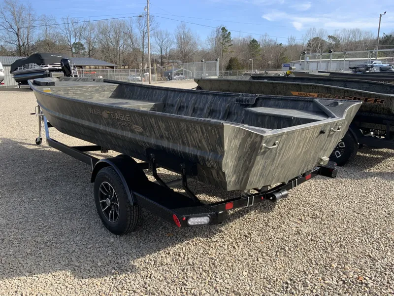 Slide: The Image of War Eagle 860LDV 2026 boat on trailer, parked outdoors. - 2
