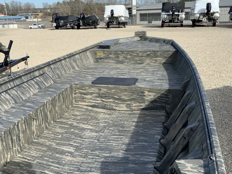 Slide: The Image of War Eagle 860LDV 2026 boat with camouflage design on gravel lot. - 4