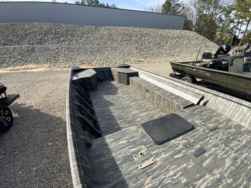 Slide: The Image of War Eagle 860LDV 2026 boat with camouflage pattern on gravel surface. - 8