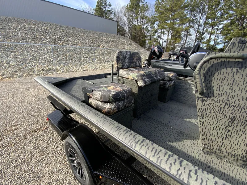 Slide: The Image of 2026 War Eagle 961BH CC boat with camouflage seats on trailer. - 11