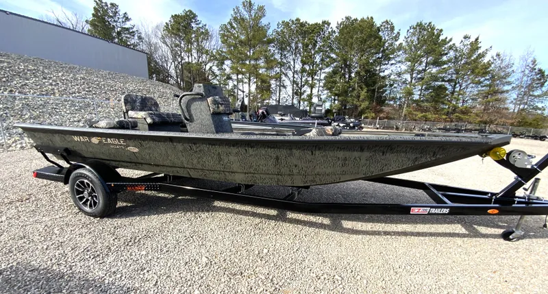 The Image of 2026 War Eagle 961BH CC boat on trailer outdoors. - 2