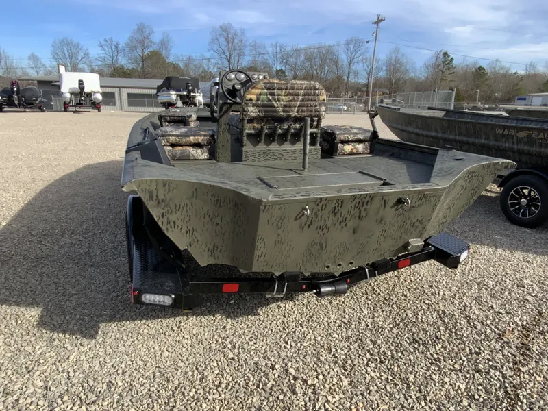 Slide: The Image of War Eagle 961BH CC 2026 boat on trailer, parked outdoors. - 3