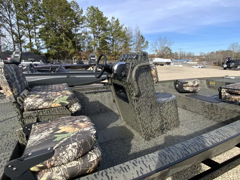 Slide: The Image of 2026 War Eagle 961BH CC boat with camouflage pattern and steering console. - 9