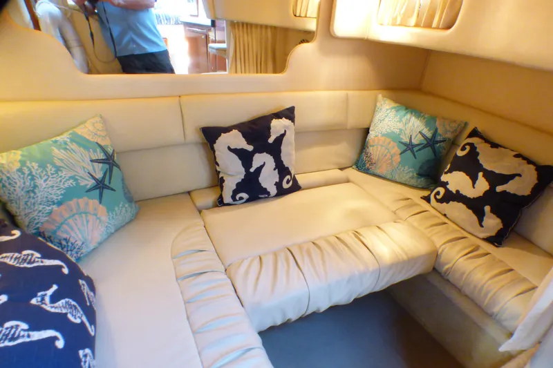 Slide: The Image of Interior of 2002 Sea Ray 340 Sundancer with nautical-themed cushions. - 10