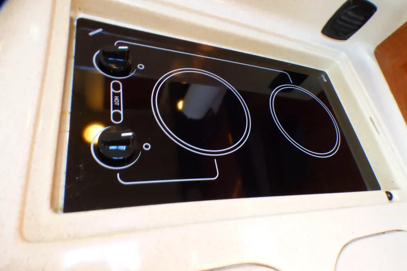 Slide: The Image of Stovetop on 2002 Sea Ray 340 Sundancer yacht, featuring dual burners and sleek design. - 14