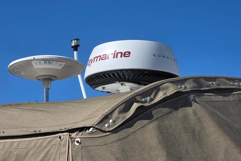 Slide: The Image of Radar and antenna on 2002 Sea Ray 340 Sundancer against clear blue sky. - 19