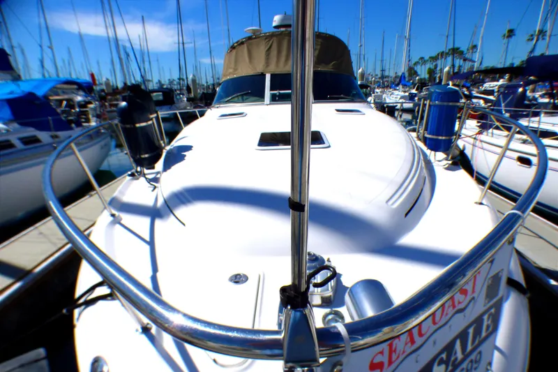 Slide: The Image of 2002 Sea Ray 340 Sundancer yacht docked at marina, surrounded by sailboats. - 2