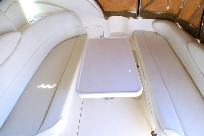 Slide: The Image of 2002 Sea Ray 340 Sundancer interior with white seating and table. - 21