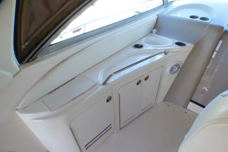 Slide: The Image of 2002 Sea Ray 340 Sundancer interior with sink, storage, and cup holders. - 22