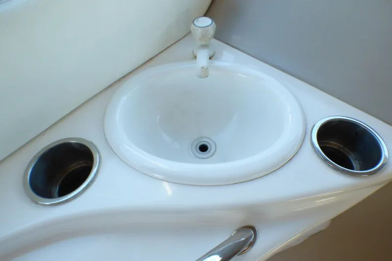 Slide: The Image of Small white sink with faucet on 2002 Sea Ray 340 Sundancer boat. - 25