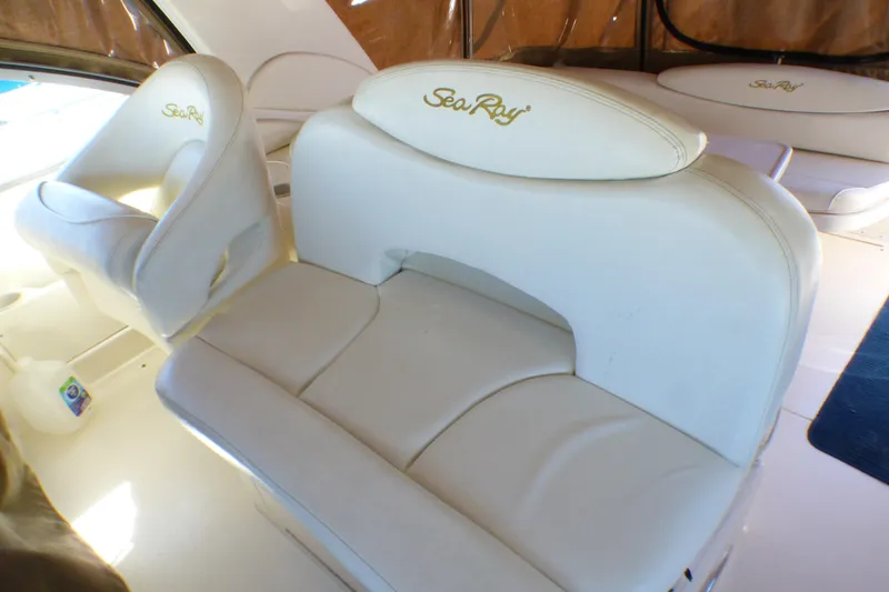 Slide: The Image of 2002 Sea Ray 340 Sundancer interior with white leather seating and embroidered logo. - 27