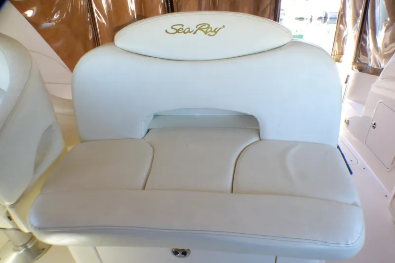 Slide: The Image of White leather seat on 2002 Sea Ray 340 Sundancer boat, featuring embroidered logo. - 28