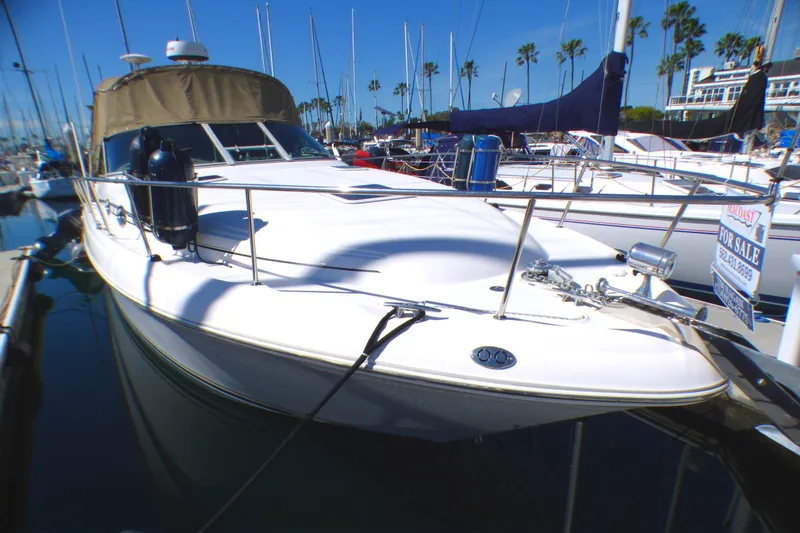 Slide: The Image of 2002 Sea Ray 340 Sundancer yacht docked, for sale sign visible. - 3